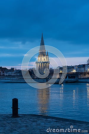 Night view of the Tour de la lanterne in La Rochelle, France. beautiful reflections in the harbor water Stock Photo