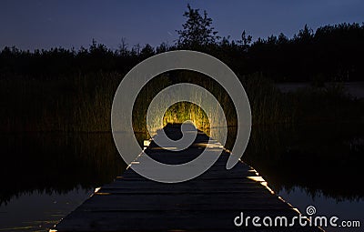 Wooden bridge over the river that leads into the Woods Stock Photo