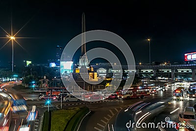 Night view of Victory Monument in the Ratchathewi district of Bangkok, Thailand, with a lot of traffic in the roundabout Stock Photo