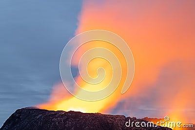 Night volcanic eruption. Fresh hot lava, flames and poisonous gases going out from the crater Stock Photo