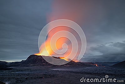 Night volcanic eruption. Fresh hot lava, flames and poisonous gases going out from the crater Stock Photo