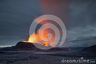 Night volcanic eruption. Fresh hot lava, flames and poisonous gases going out from the crater Stock Photo