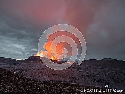 Night volcanic eruption. Fresh hot lava and poisonous gases going out from the crater Stock Photo