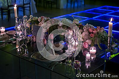 Night wedding decoration with candles and natural flowers Stock Photo