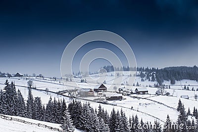 Nightime top view of remote village surrounded by snow Stock Photo