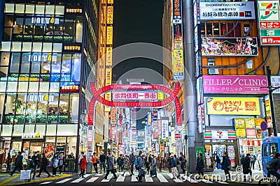 Nightlife in Kabukicho, the entrance of Kabukicho entertainment Red Light district in Shinjuku Ward, Tokyo. Billboards and Crowd Editorial Stock Photo