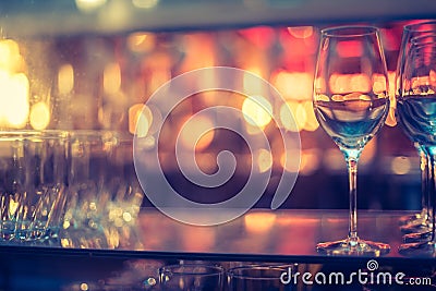 Nightlife: Wine glasses and colourful lights in a night club Stock Photo