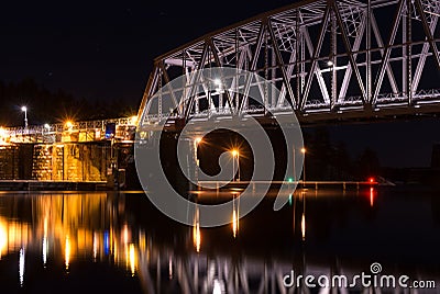 Nightly railroad bridge and calm water Stock Photo