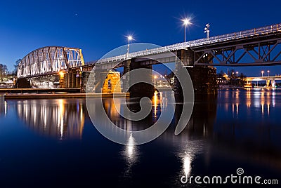 Nightly railroad bridge over stream Stock Photo