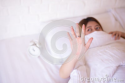 Nightmare or bad dream,Asian woman with fear and panic while lying down under the blanket in bedroom Stock Photo