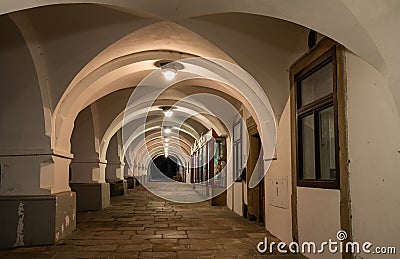 Nightscape of illuminated arcade in renaissance building on Husovo square, Nove Mesto nad Metuji, Czech Republic Stock Photo
