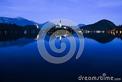 Nightscape of Lake Bled with Alps at background and blue water Stock Photo