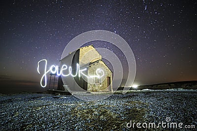 Nightscape with light painting of polish male name Jacek Stock Photo