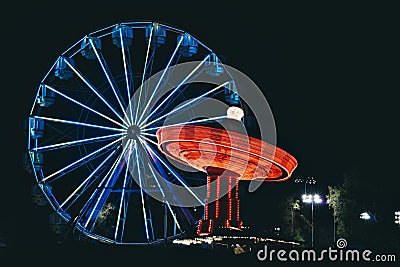 Nighttime with a Ferris Wheel and Swing Stock Photo