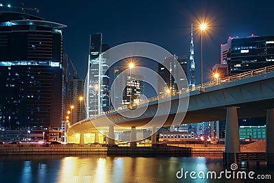 Nighttime skyline of Dubai with modern buildings, street lights and a bridge Stock Photo