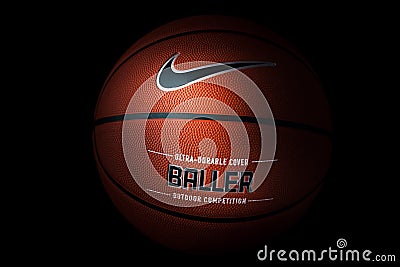 Nike brand, basketball ball Nike Baller. Orange rubber outdoor ball, ultra-durable cover, close-up on a black background Editorial Stock Photo