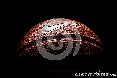 Nike brand, basketball ball Nike Baller. Orange rubber outdoor ball, ultra-durable cover, close-up on a black background Editorial Stock Photo