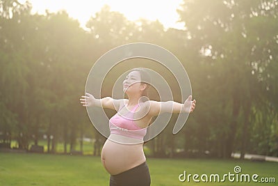 Asian Eastern Chinese happy beautiful pregnant woman hug embrace sunshine sunset sunrise nature in forest outdoor full of hope Stock Photo