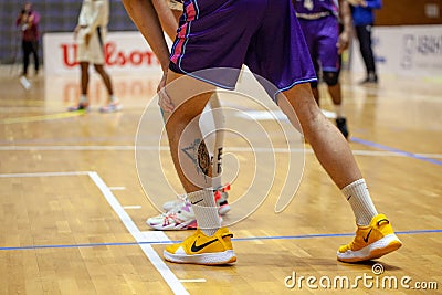 Nike yellow basketball shoes on parquet floor during basketball match Editorial Stock Photo