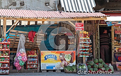 A market place with a lot of different and colorful vegetables, fruits, snacks and toys for sale Editorial Stock Photo