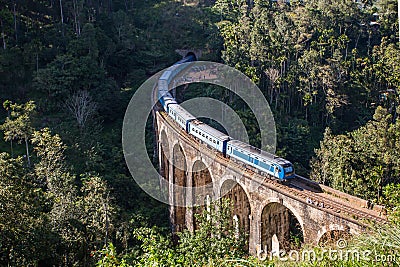 Nine Arches Bridge and blue train in Sri Lanka, Ella. Stock Photo