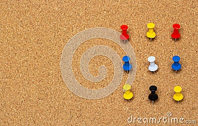 Nine colored pinned button on a cork board Stock Photo