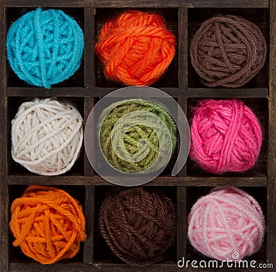 Nine colorful balls of yarn in printers box Stock Photo