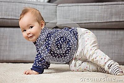 Nine months old baby girl on the floor Stock Photo