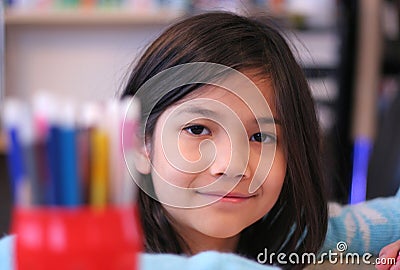 Nine year old girl coloring Stock Photo