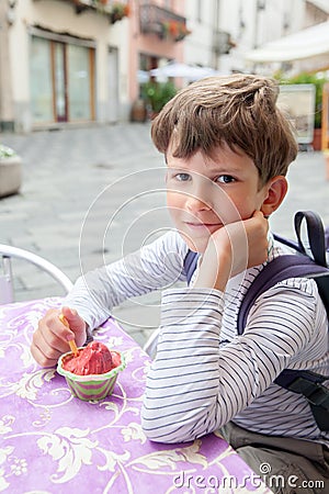 Nine years boy eating berry ice cream Stock Photo