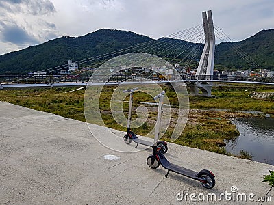Ninebot by Segway ES2 Kickscooter park near the suspension bridge in Gohyeon-dong Editorial Stock Photo