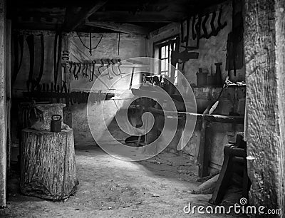 A nineteen century old empty desolate dirty locksmith workshop Stock Photo