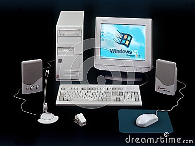 Nineties obsolete tower pc computer and Windows 95 logo on screen Editorial Stock Photo