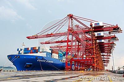 NINGBO ZHOUSHAN, CHINA - March 2018: Ningbo Zhoushan industrial shipping port on a busy day, cargo containers being Editorial Stock Photo