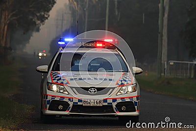 NINGI, AUSTRALIA - NOVEMBER 9 : Police holding cordon in front of bush fire front as it approaches houses November 9, 2013 in Editorial Stock Photo