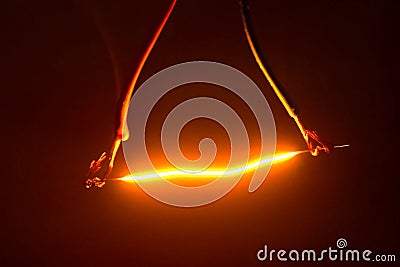 Niobium wire glows when electricity is passed through Stock Photo
