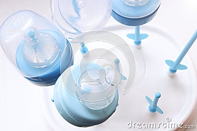 Nipples for baby feeding jars. Baby nipples dry after washing on a special support. Stock Photo