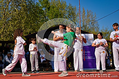 Powerful Capoeira Display: Dynamic Martial Arts Dance in the Sun Editorial Stock Photo