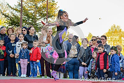 Energetic Dance and Leaping Performance by a Young Girl in Exotic Black Attire on Open Stage for World Dance Day Editorial Stock Photo