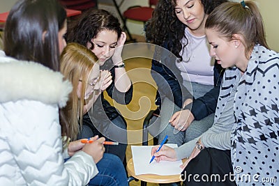 Girl draws on paper and team collaboration meeting start up. Female diversity young people studying working together Editorial Stock Photo