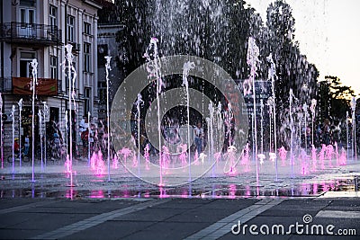 Fountain on the town square with purple water in a sunset Editorial Stock Photo