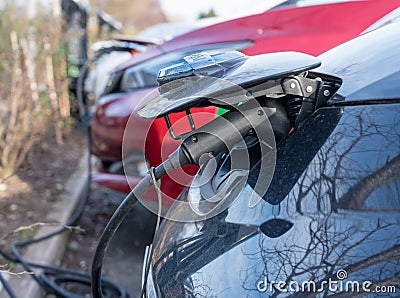 Nissan electric car being recharged in parking lot Editorial Stock Photo