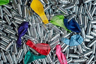 Nitrous oxide canisters / cream puff chargers and balloons: steel cylinders contain nitrous oxide / laughing gas for legal high Stock Photo