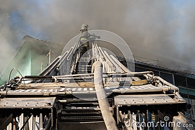 Nizhnevartovsk, Russia - July 1, 2019: The roof of a residential house is burning. firefighters extinguish a fire on the Editorial Stock Photo