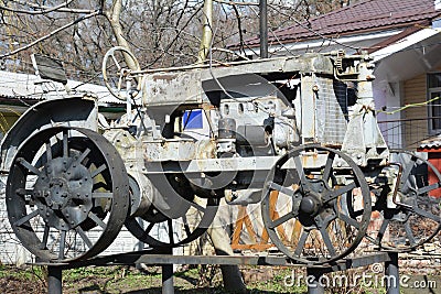 Veteran metal tractor with steel wheels of 1930-s of a local history museum in Nizhyn, Ukraine Stock Photo