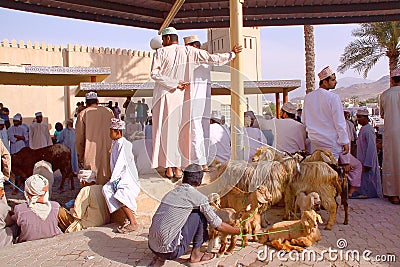 NIZWA, OMAN - FEBRUARY 3, 2012: Omani men traditionally dressed attending the Goat Market in Nizwa Editorial Stock Photo