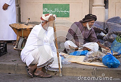 Old omani man selling dry fish at a market in Nizwa Editorial Stock Photo