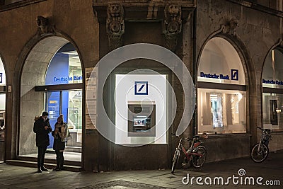 Deutsche Bank logo and ATM on one of their Munich branches taken during a snowy night. Editorial Stock Photo