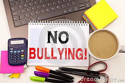 No Bullying text in the office with surroundings such as laptop, marker, pen, stationery, coffee. Business concept for Bullies Pre Stock Photo