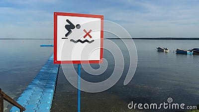 No Diving sign at beach, lake Naroch, Belarus. Warning sign of shallow water. Warning notice sign do not jump in water Stock Photo